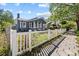 Charming home exterior with white picket fence and lush landscaping at 1115 Crescent Lake N Dr, St Petersburg, FL 33701