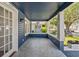 Inviting front porch with tiled floor and wood trim, a perfect spot for relaxation at 1115 Crescent Lake N Dr, St Petersburg, FL 33701