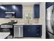 Modern kitchen with stainless steel appliances, blue cabinets and designer backsplash at 1115 Crescent Lake N Dr, St Petersburg, FL 33701