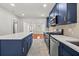 Bright kitchen showcasing navy cabinets, stainless steel appliances, and white countertops at 1115 Crescent Lake N Dr, St Petersburg, FL 33701