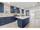 Modern kitchen with stainless steel appliances, a center island, and stylish blue cabinetry at 1115 Crescent Lake N Dr, St Petersburg, FL 33701