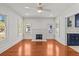 Bright living room with hardwood floors, a brick fireplace and plentiful natural light at 1115 Crescent Lake N Dr, St Petersburg, FL 33701