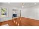 Bright living room featuring gleaming hardwood floors and an open layout leading to the kitchen at 1115 Crescent Lake N Dr, St Petersburg, FL 33701