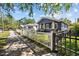 Charming blue home with a fenced yard on a quiet street provides a welcoming curb appeal at 1115 Crescent Lake N Dr, St Petersburg, FL 33701