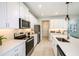 Modern kitchen with stainless appliances, quartz countertops, and wood-look flooring at 1138 Creek Valley Ct, Brandon, FL 33511