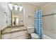 Bathroom with granite vanity and shower with fun blue shower curtain at 115 112Th Ne Ave # 1027, St Petersburg, FL 33716