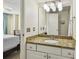 Bright bathroom with a large granite counter and is conveniently located next to the bedroom at 115 112Th Ne Ave # 1027, St Petersburg, FL 33716
