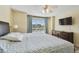 Bedroom features a TV, window view, wood floors, and a dresser at 115 112Th Ne Ave # 1027, St Petersburg, FL 33716