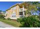 Charming multi-level home featuring a screened porch and balcony, surrounded by lush landscaping at 115 112Th Ne Ave # 1027, St Petersburg, FL 33716