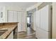 Efficient kitchen with white cabinets, stainless steel appliances, and a view to another room at 115 112Th Ne Ave # 1027, St Petersburg, FL 33716