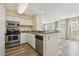 Modern kitchen featuring stainless steel appliances, granite countertops, and a breakfast bar at 115 112Th Ne Ave # 1027, St Petersburg, FL 33716