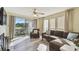 Sun-drenched living room boasting balcony access, wood floors, and a cozy seating area at 115 112Th Ne Ave # 1027, St Petersburg, FL 33716