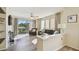 Comfortable living room with a fireplace, balcony access, and ample natural light at 115 112Th Ne Ave # 1027, St Petersburg, FL 33716