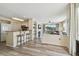 Open-concept living room featuring a breakfast bar, a fireplace, and access to a balcony at 115 112Th Ne Ave # 1027, St Petersburg, FL 33716
