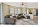 Spacious living room with stylish wood floors, large windows, and comfortable seating arrangement at 115 112Th Ne Ave # 1027, St Petersburg, FL 33716