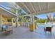 Charming patio area with seating, overlooking a sparkling pool and lush tropical landscaping at 115 112Th Ne Ave # 1027, St Petersburg, FL 33716