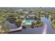 Aerial view of a community pool and clubhouse on a peninsula, accessible via a charming wooden bridge at 115 112Th Ne Ave # 1027, St Petersburg, FL 33716