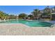 Inviting community pool with a paved deck, gazebo and pergola for relaxation and outdoor enjoyment at 115 112Th Ne Ave # 1027, St Petersburg, FL 33716