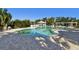 Inviting community pool with a paved deck, gazebo and pergola for relaxation and outdoor enjoyment at 115 112Th Ne Ave # 1027, St Petersburg, FL 33716