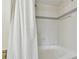 Bathroom shower with white tile and silver trim at 115 112Th Ne Ave # 1027, St Petersburg, FL 33716