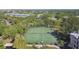 Aerial view of well-maintained tennis courts surrounded by lush greenery, perfect for recreational activities at 115 112Th Ne Ave # 1027, St Petersburg, FL 33716