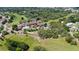 Aerial view of community clubhouse on golf course, lush landscaping, and inviting pool at 11510 Moffat Pl, Temple Terrace, FL 33617