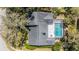 Aerial view of the home showcasing the roof, yard, mature landscaping, and pool at 11510 Moffat Pl, Temple Terrace, FL 33617