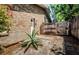 Private backyard featuring brick wall, wooden fence, and desert plant at 11510 Moffat Pl, Temple Terrace, FL 33617