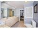 Spacious bathroom featuring double sinks, a large mirror, and a walk-in shower at 11510 Moffat Pl, Temple Terrace, FL 33617
