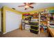 Bedroom with a closet, ceiling fan, and storage shelves providing ample room for belongings at 11510 Moffat Pl, Temple Terrace, FL 33617