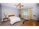 Bright bedroom with modern ceiling fan, wood-look floors, and cozy furnishings at 11510 Moffat Pl, Temple Terrace, FL 33617