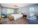 Bright bedroom with cool grey walls, wood-look floors, and a large window at 11510 Moffat Pl, Temple Terrace, FL 33617