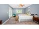 Cozy bedroom featuring cool grey walls, a ceiling fan, and a glass door to the outside pool area at 11510 Moffat Pl, Temple Terrace, FL 33617