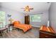 Well-lit bedroom features a ceiling fan, a large window, and luxury vinyl plank flooring at 11510 Moffat Pl, Temple Terrace, FL 33617