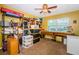 Cozy bedroom with a ceiling fan, window providing natural light, and ample storage solutions at 11510 Moffat Pl, Temple Terrace, FL 33617