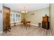 Bright dining room with hardwood floors and a charming chandelier, perfect for Gathering meals at 11510 Moffat Pl, Temple Terrace, FL 33617