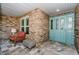 Inviting front entryway with decorative blue doors, brick accents, and outdoor seating at 11510 Moffat Pl, Temple Terrace, FL 33617