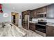 Well-appointed kitchen featuring granite countertops, stainless steel appliances, and a breakfast bar at 11510 Moffat Pl, Temple Terrace, FL 33617