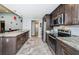 Modern kitchen featuring stainless steel appliances, granite countertops, and ample cabinet space at 11510 Moffat Pl, Temple Terrace, FL 33617