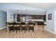 Modern kitchen with an island, stainless steel appliances, pendant lighting, and wood-look flooring at 11510 Moffat Pl, Temple Terrace, FL 33617