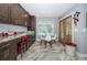 Cozy breakfast nook adjacent to the kitchen with a glass table and view to the yard at 11510 Moffat Pl, Temple Terrace, FL 33617