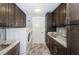 Functional laundry room with modern cabinetry, granite countertops, and a front-load washer and dryer at 11510 Moffat Pl, Temple Terrace, FL 33617