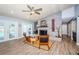 Inviting living room with a brick fireplace, ceiling fan, and access to the lanai with a pool view at 11510 Moffat Pl, Temple Terrace, FL 33617