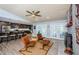 Spacious living area with a fireplace, modern seating, a view of the lanai, and easy access to the kitchen at 11510 Moffat Pl, Temple Terrace, FL 33617