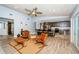 Open-concept living room with a kitchen, features modern furnishings, ceiling fan, and wood-look flooring at 11510 Moffat Pl, Temple Terrace, FL 33617