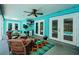 Bright patio with ceiling fan and comfortable seating overlooking the pool at 11510 Moffat Pl, Temple Terrace, FL 33617