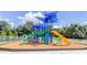 Colorful community playground featuring multiple slides and climbing structures, perfect for Gathering fun at 11510 Moffat Pl, Temple Terrace, FL 33617