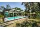 Outdoor screened-in pool featuring a lounge area and beautifully maintained backyard at 11510 Moffat Pl, Temple Terrace, FL 33617