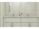 Bright bathroom featuring double sinks, quartz countertop, and sleek white cabinetry at 11864 Blue Diamond Trl, Parrish, FL 34219