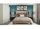 Modern bedroom showcasing a bed with throw pillows, table lamps, and accent artwork at 11864 Blue Diamond Trl, Parrish, FL 34219